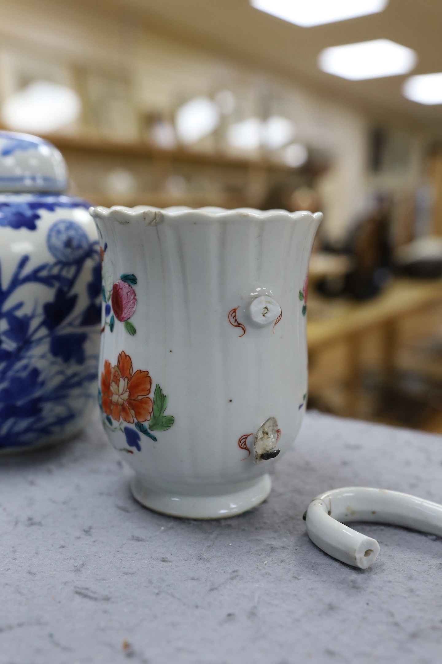 A Chinese blue and white jar and cover, Kangxi mark late 19th century and an 18th century Chinese famille rose mug. 15.5cm high